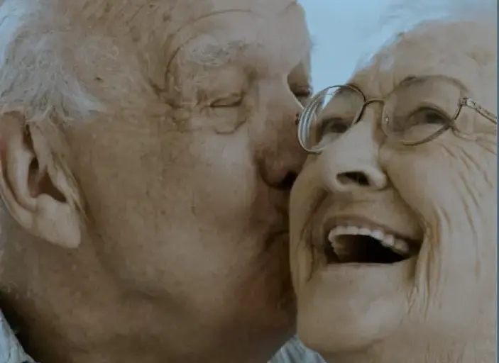 elderly-couple-head-shot-man-kissing-womans-cheek.png