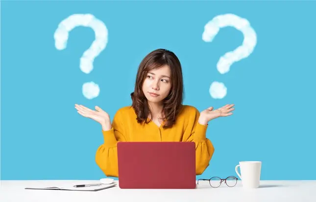 woman on laptop with questions