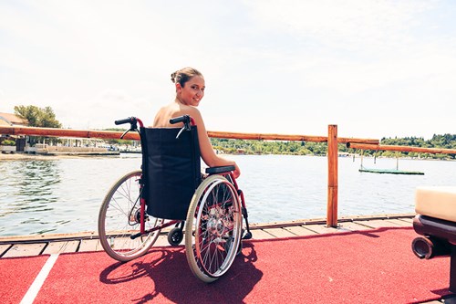 woman in wheelchair on pier