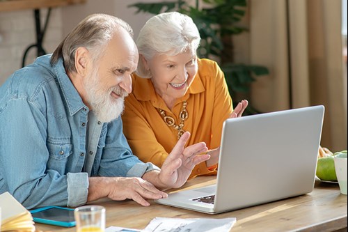 happy senior couple on video call