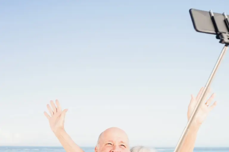 older-couple-taking-selfie-on-the-beach.jpg