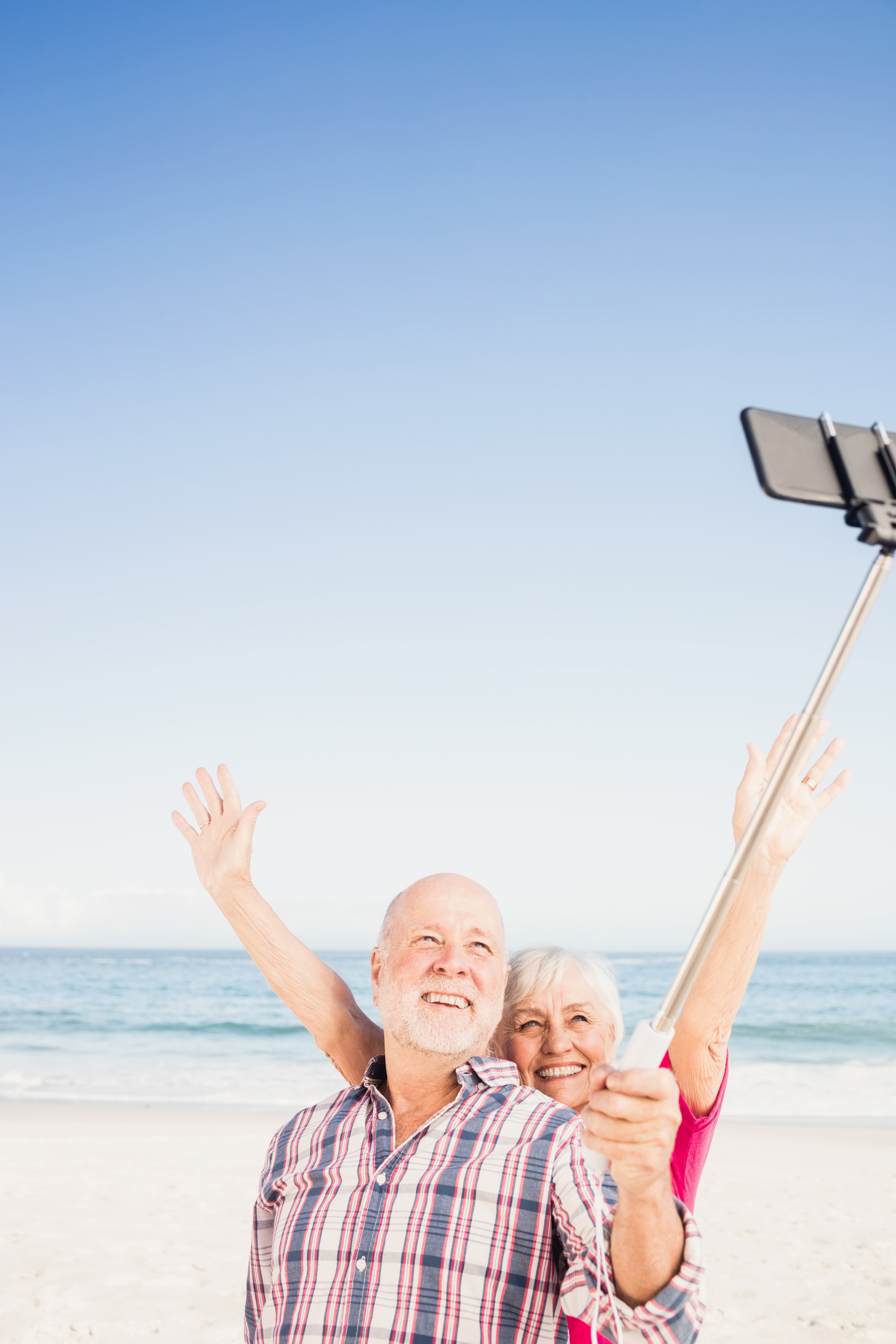 older-couple-taking-selfie-on-the-beach.jpg