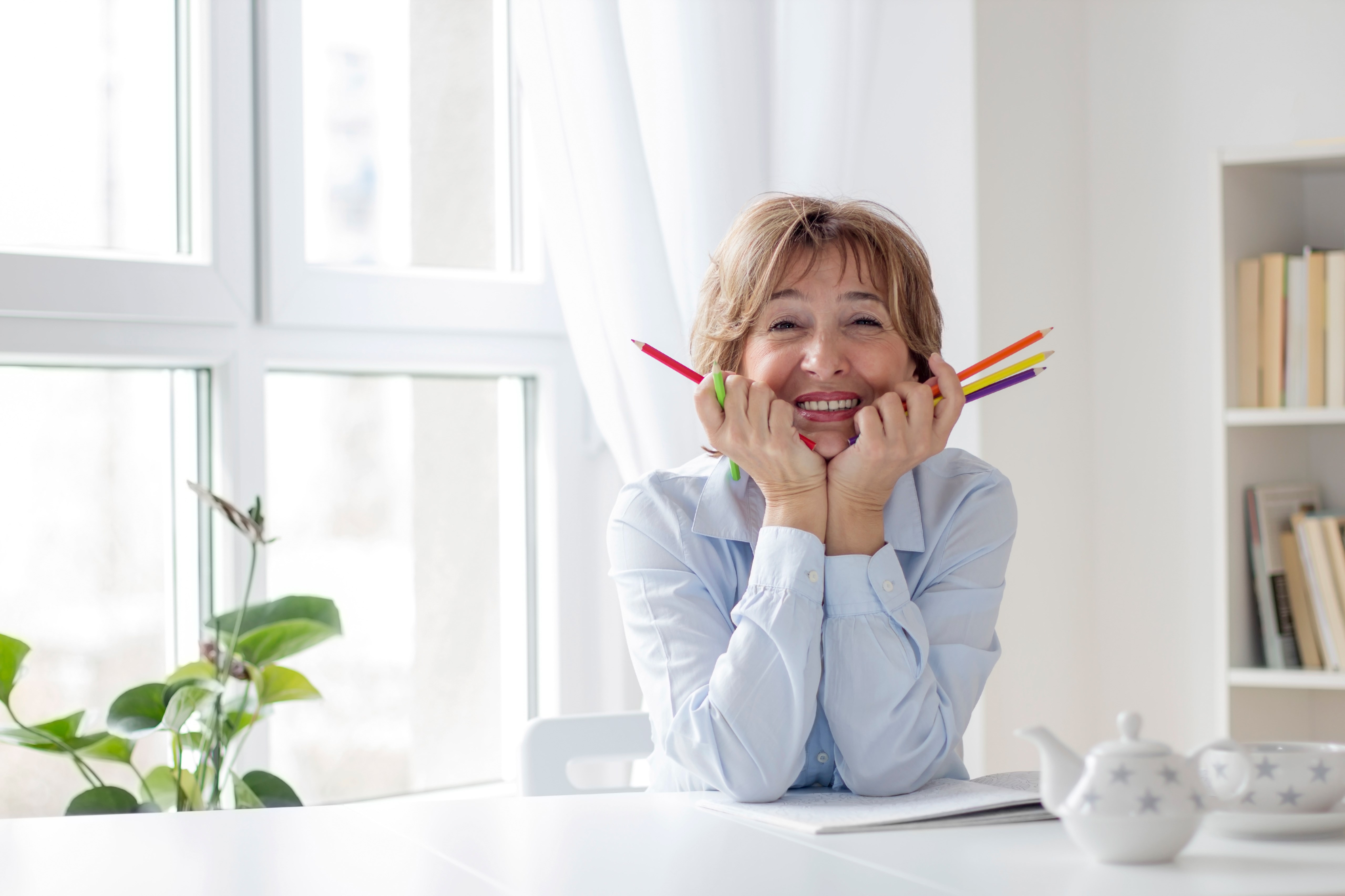older-woman-holding-colored-pencils.jpg