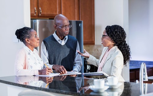 senior couple talking with advisor