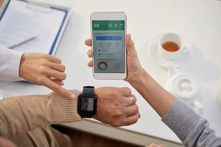senior man checking smartwatch with mobile app