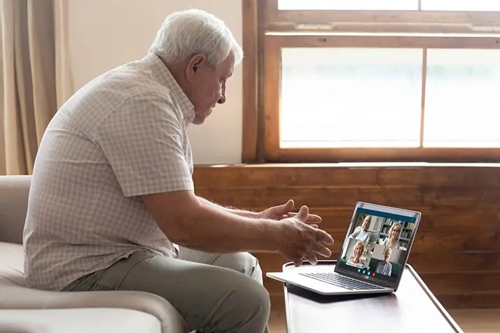 senior man on zoom call with family