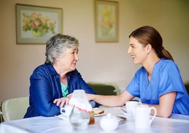 senior with caregiver eating