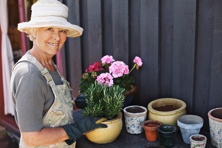 senior woman planting flowers
