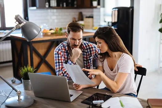 man and woman discussing an issue while sitting at a table