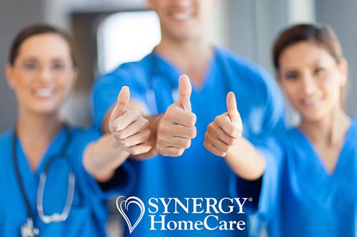 SYNERGY HomeCare caregivers with thumbs up