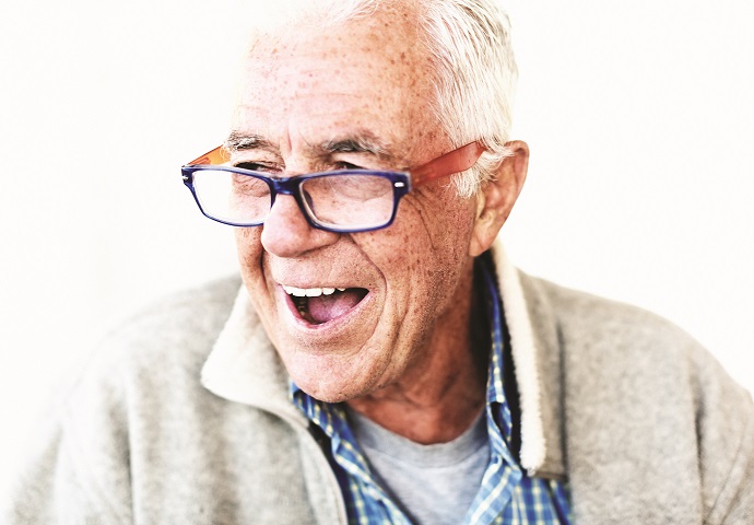 Cheerful and relaxed senior man in eyeglasses smiles