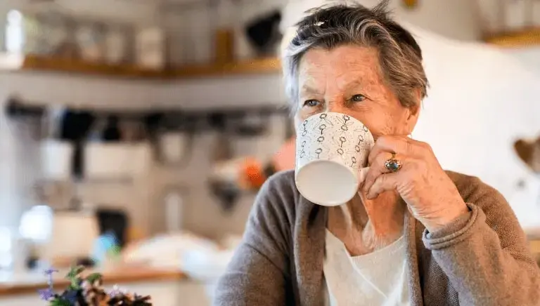 senior woman drinking a cup of coffee