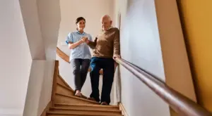 Senior caregiver providing safety assistance to elderly client in his home in Tucson, AZ