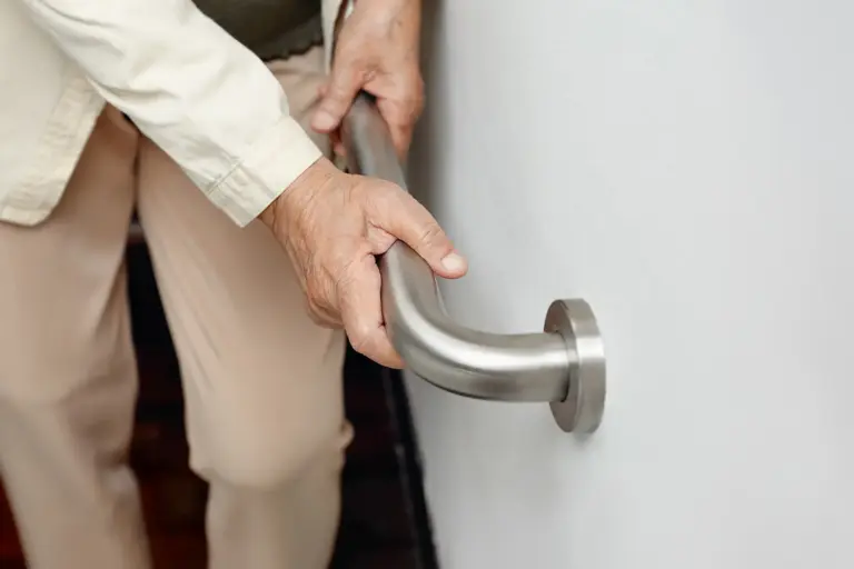 senior holding railing for support