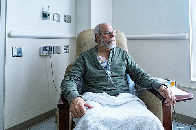 senior male in hospital room sitting