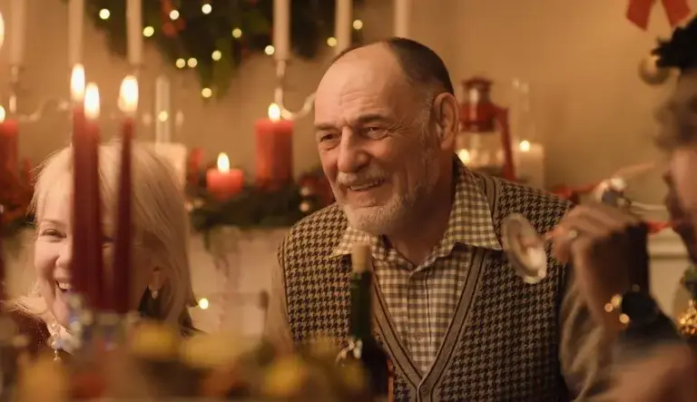 Happy Senior Man Enjoying Holiday Dinner with Family