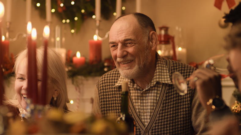 Happy Senior Man Enjoying Holiday Dinner with Family