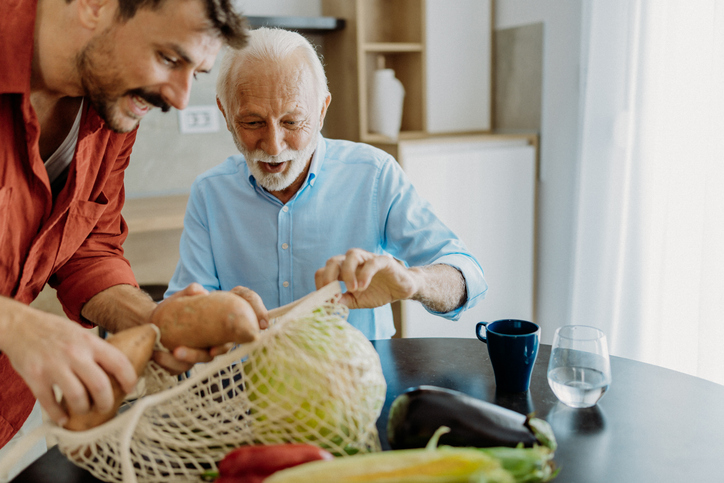 Son helping his father with cooking