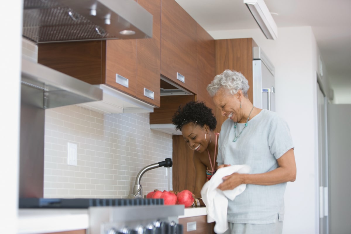 two woman enjoying cooking together
