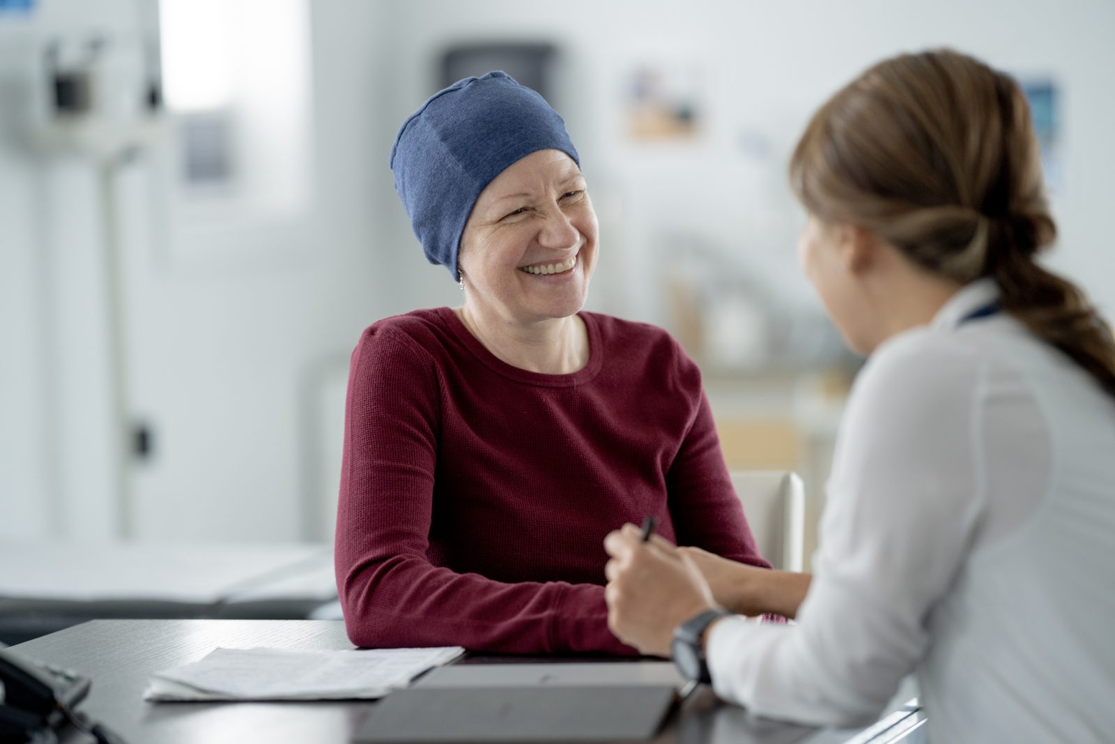 Cancer survivor consulting with a healthcare advisor about a personalized survivorship care plan in a comfortable setting.