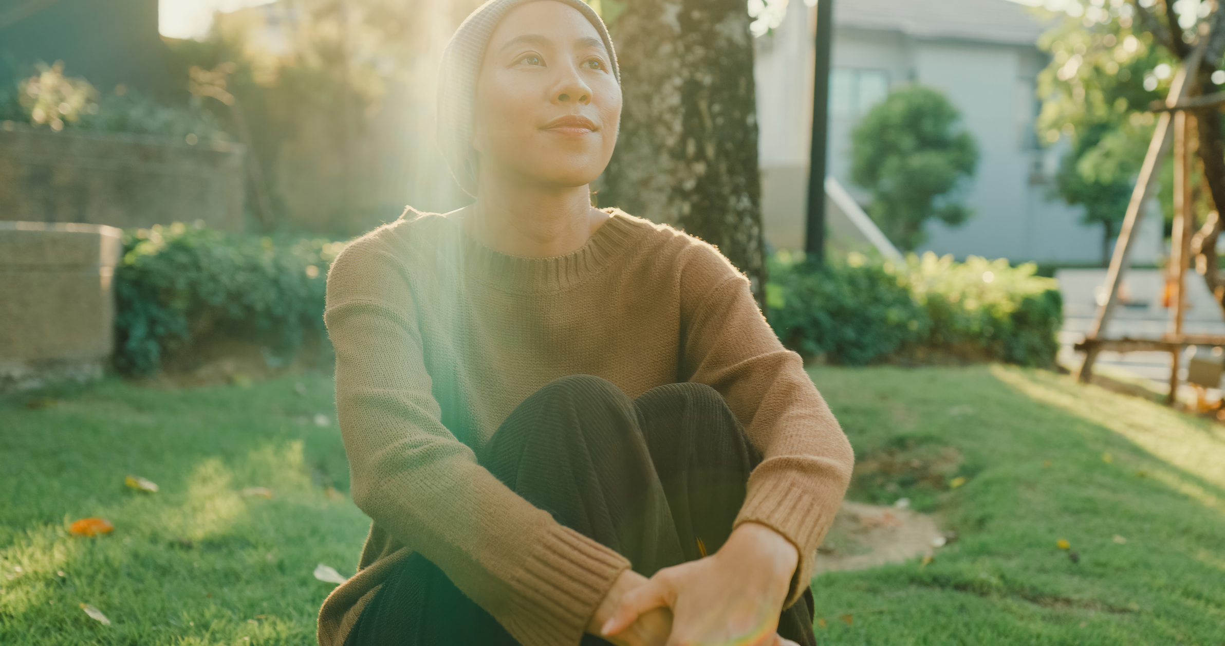 Cancer survivor sitting peacefully outdoors, symbolizing recovery and hope during National Cancer Survivor Month